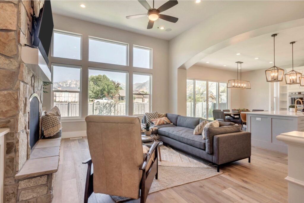 The room is a living space with high ceilings and large windows allowing natural light to enter.